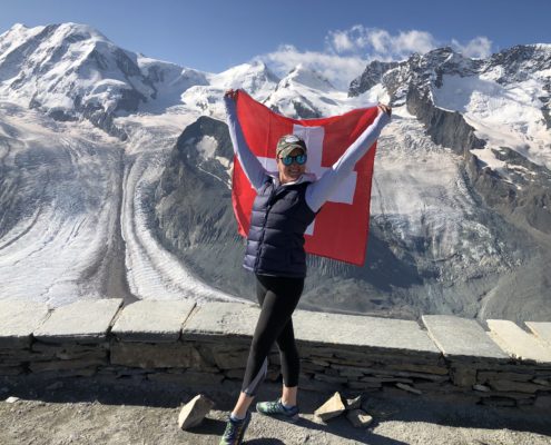 Zermatt Alps woman holding Swiss flag